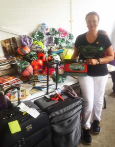 National President of The Links, Incorporated Dr. Glenda Newell-Harris with many of the school gifts.