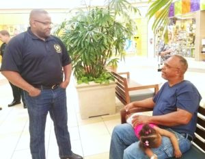 Pictured is Sheriff Darryl Daniels talking  with mall shopper Jerome Mayweather.
