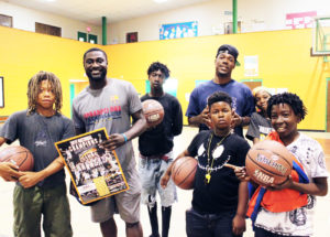Shown is Jacksonville native Tyrell Johnson, overseas player for El Salvador LMB and Jacksonville Giant basketball player Keith McDougal shooting the hoops with Eureka Gardens student residents. 