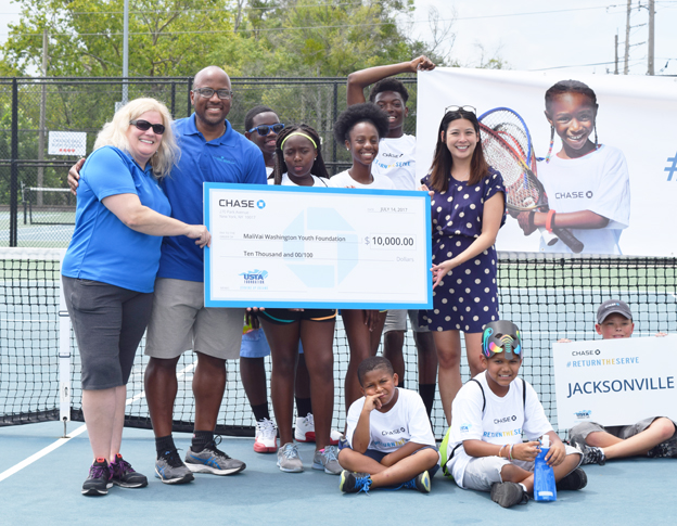  Pictured showcasing the awarded check left to right is Jackie Materasso, USTA Foundation, MaliVai Washington, Founder, Nyreon Shuman, Mauricia Brown, Tiah Thomas-Jacobs and Traveon Harris. Seated L to R: Trey Scott, Christian Thomas and Isaiah Pickett. 