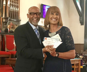 Shown is Mt. Zion Allenites president Olivia Young presenting the check to Reverend Pearce Ewing, Sr. 