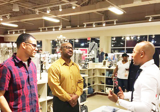 Ladies Night Out was not just for women but for men, too. Jeremiah Cobb of The Bello Mo Group, shares a few fashion style tips and fabric swatches with Glenn Turner (left) and Kelvin Kay (rt).