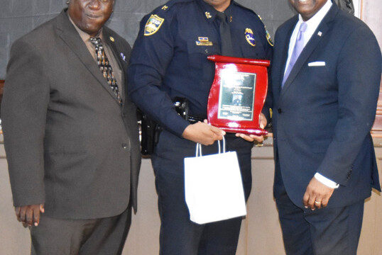 Chief F. Travis Cox accepting award for Chief T.K. Waters