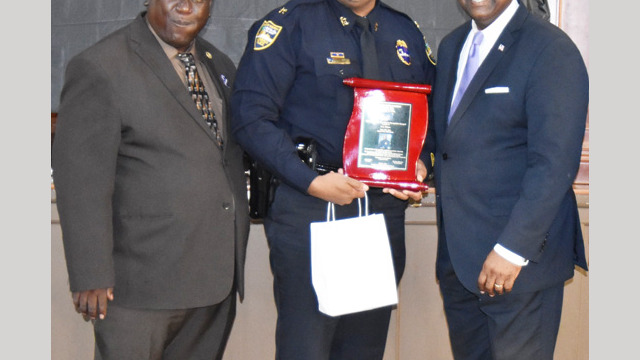 Chief F. Travis Cox accepting award for Chief T.K. Waters